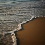 a close up of a wave on a beach